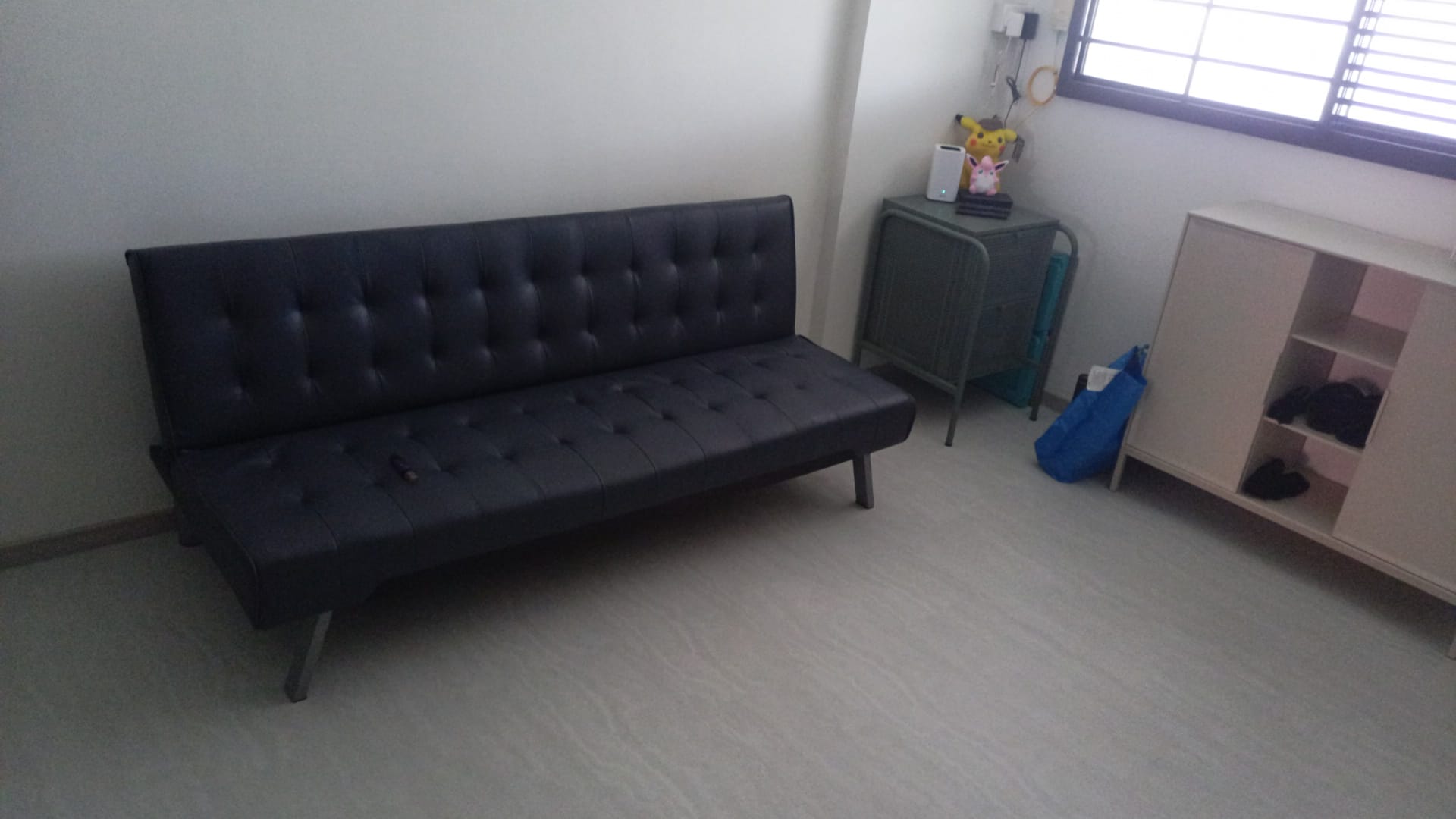 Customer home photo 6: The price is cheap and the quality is good. Color wise is a bit different as it's not exactly grey as how one can imagine but it's gonna look like dark blue. Usage wise is useful for when I have a few guests coming over as the back rest can be brought down for guests to sit all around it. Size is just nice for my 3 room flat hall. Just need to be careful as there is no support in the middle so if u have heavy guests sitting in the middle u can feel the sofa will bend a lil coz of the weight. Not an issue just a simple observation by me. Overall satisfied with the product.