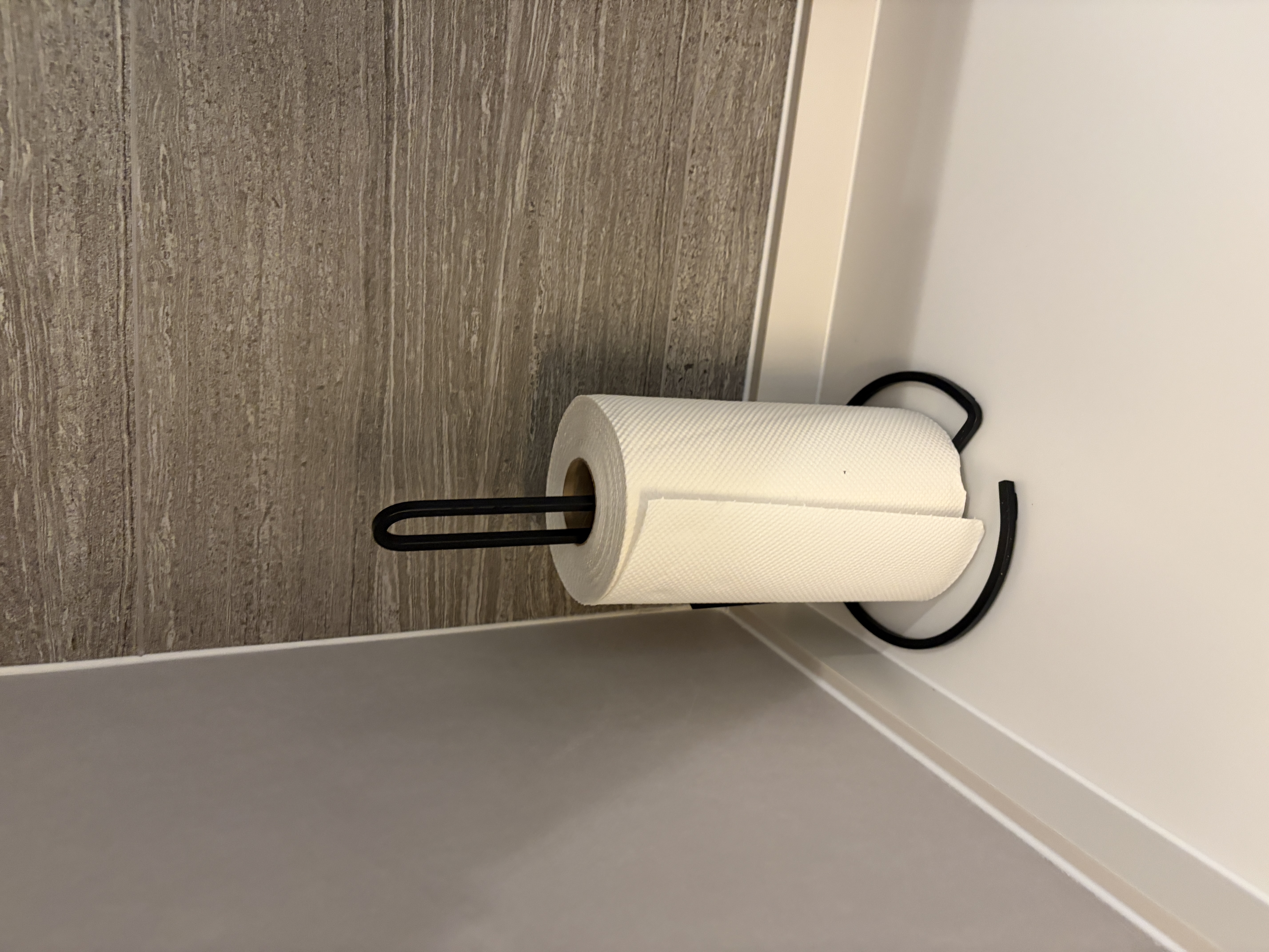 Customer home photo 1: This paper towel holder is sleek and fits my space perfectly