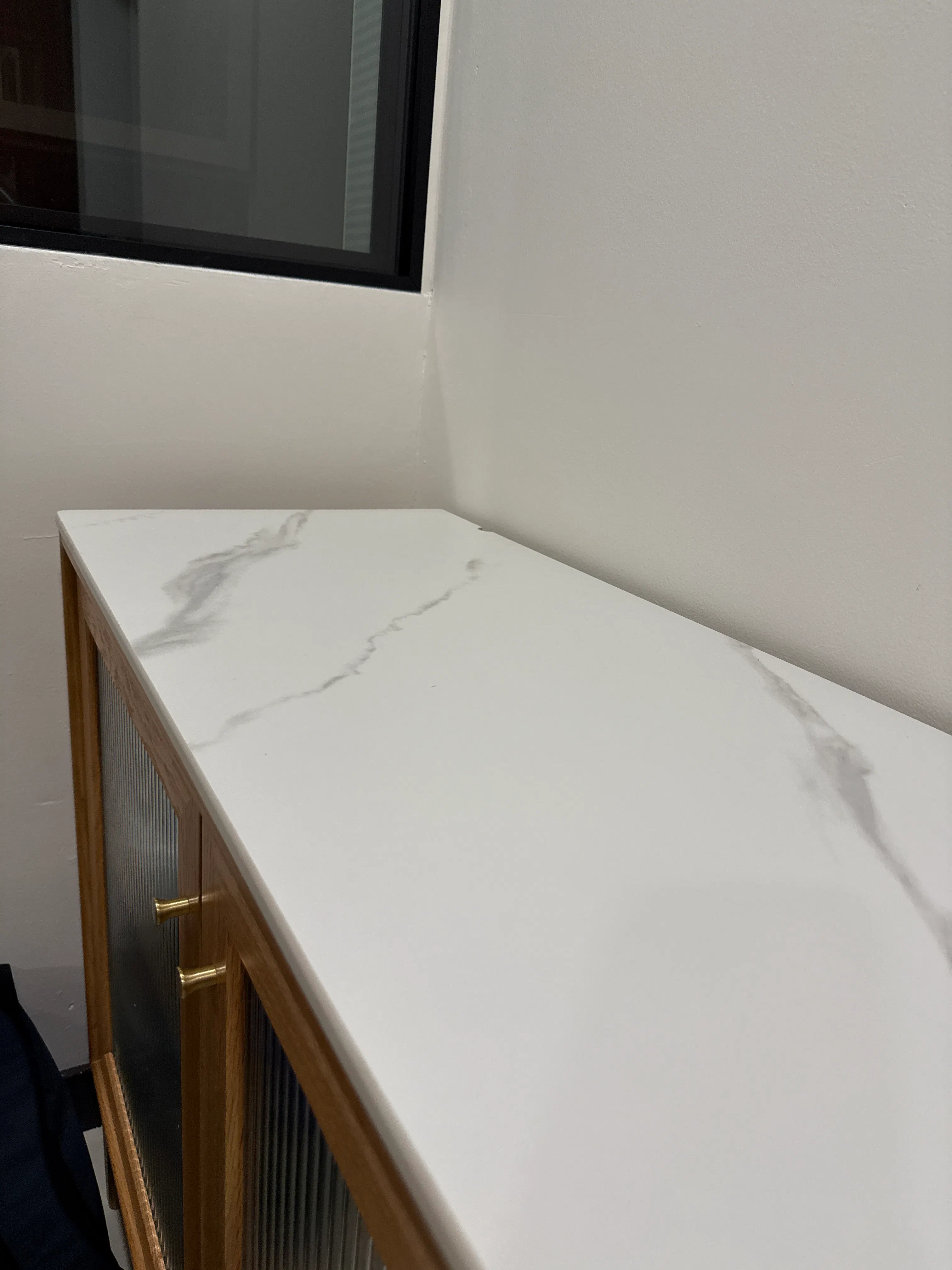 Customer home photo 1: Solid, heavy sideboard that fits my dining interior effortlessly. The sintered stone top also has a beautiful design and texture to it.