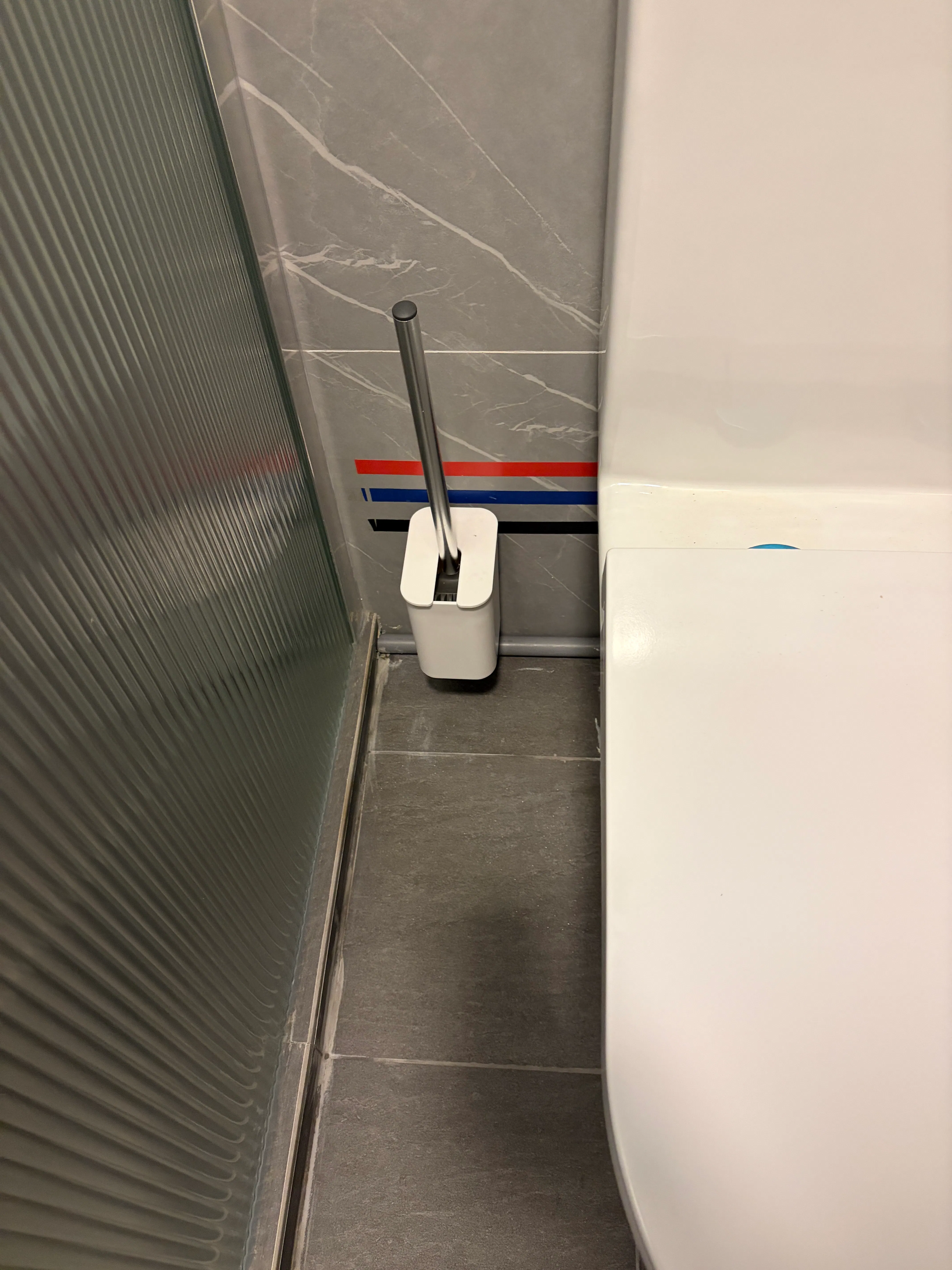 Customer home photo 1: The design of this brush is contemporary and sleek, and fits well in my toilet