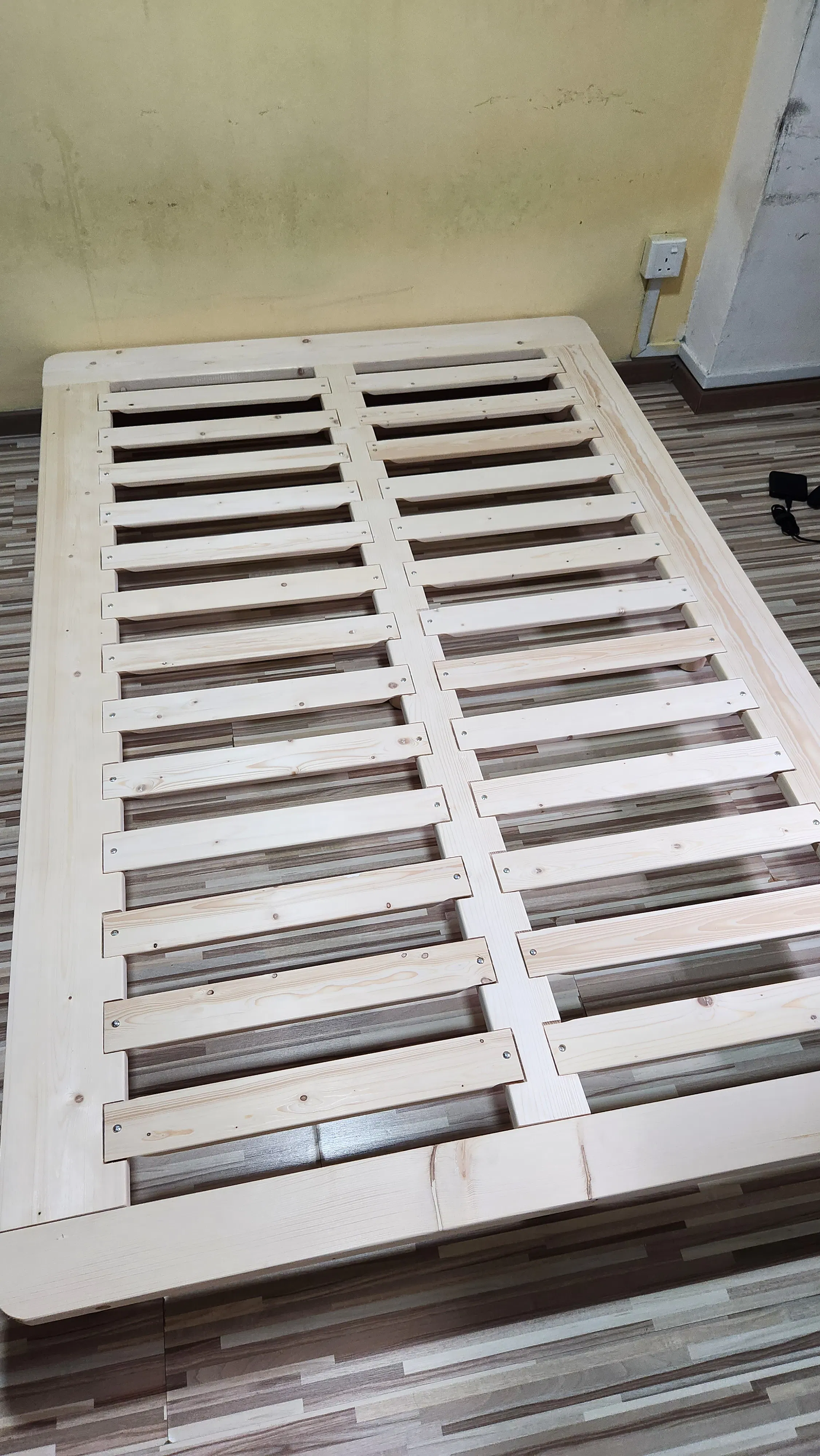 Customer home photo 1: There's this woody smell since assembling it and it fits really nicely for small items on the sides. Good compliment to my new mattress