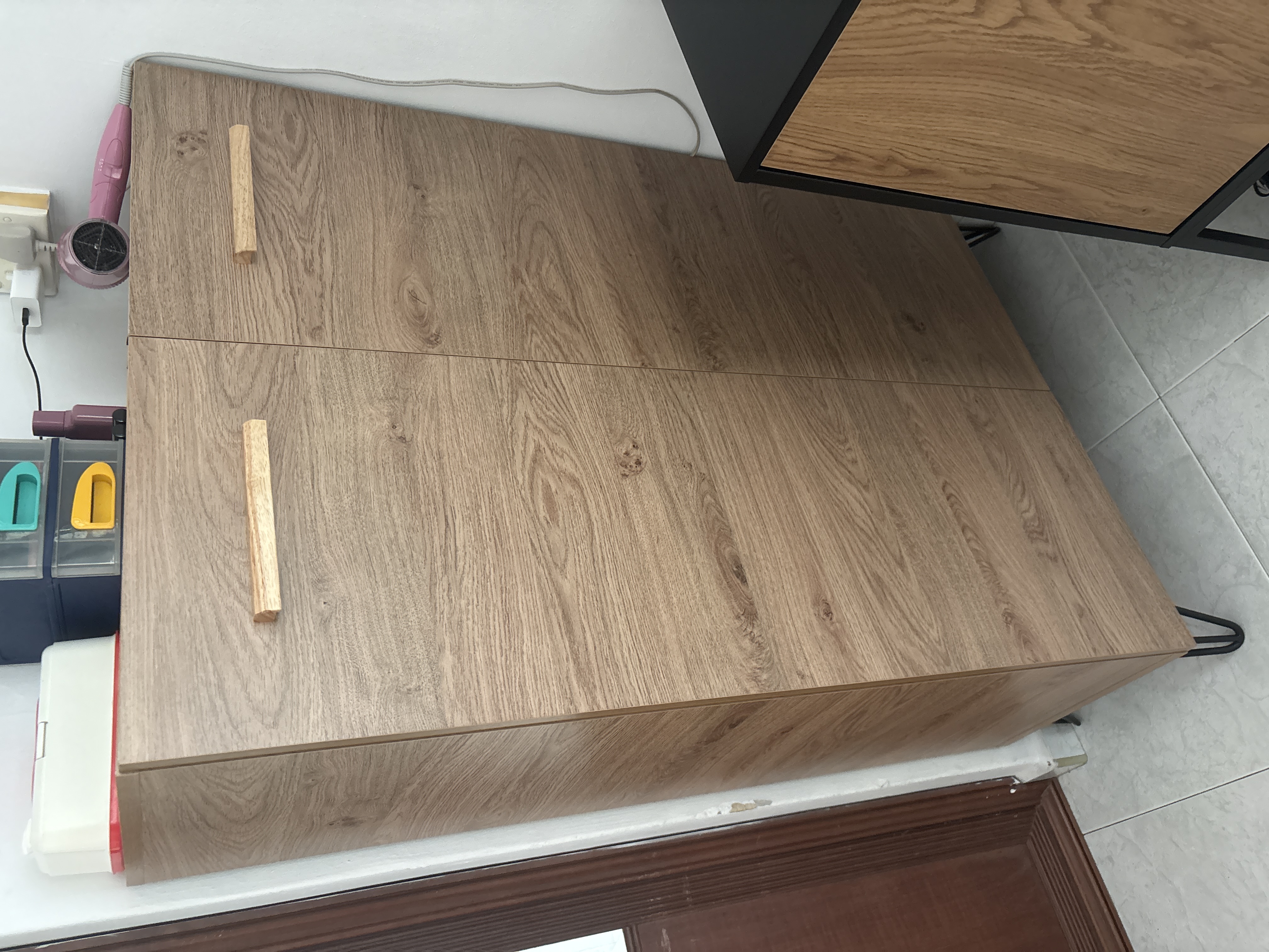 Customer home photo 1: Tall and sturdy shoe cabinet, good size for storage of many shoes. Nice color and design.