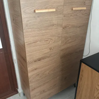 Customer home photo 1: Tall and sturdy shoe cabinet, good size for storage of many shoes. Nice color and design.