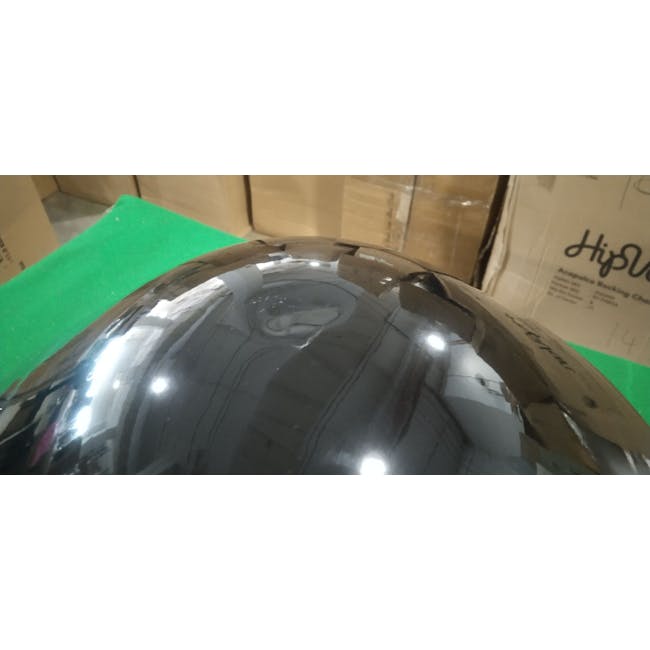 (As-is) Klari Table Lamp - Black - 4 - Reflective metallic helmet placed on green foam, Interior view of a shiny, reflective