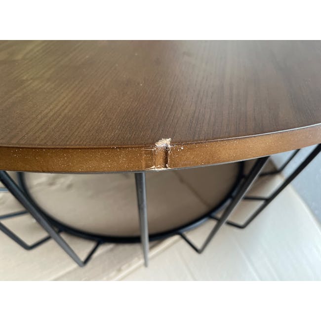 (As-is) Freida Round Coffee Table - Black, Cocoa - 2 - 4 - Wooden table with visible damage, metal frame underneath