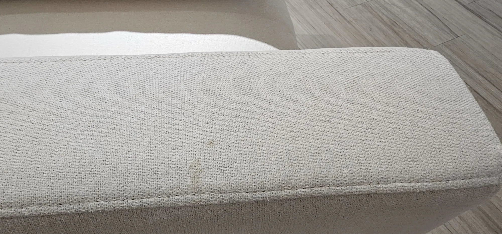 (As-is) Russell Armless Unit - Oat (Eco Clean Fabric) - 10 - Light beige fabric, textured surface, small stain, minor